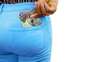 Black lady putting few Botswanan Pula notes into her back pocket. Removing money from pocket, hold money photo