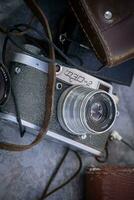 Daugavpils, Latvia  16 09 2023 Old FED 2 camera without a leather case at flea market lying between other cameras photo