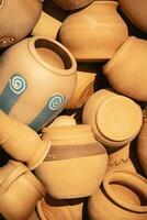 Variety of randomly placed clay pots close up photo