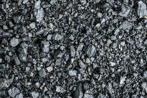 Black coal stones and pebbles from a coal store, Texture background for design, Coal stone texture background photo