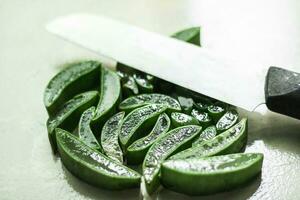 Green aloe vera on a white background with a knife, Cutting aloe vera background photo