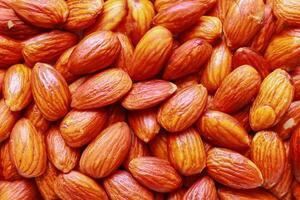 Close up of almonds, Background of big raw peeled almonds, Peeled almonds closeup background photo