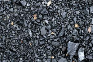 Black coal stones and pebbles from a coal store, Texture background for design, Coal stone texture background photo