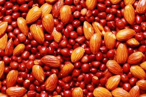 Close-up of almonds and peanuts, Background of big raw peeled almonds and peanuts, Peeled almonds and peanuts closeup background photo