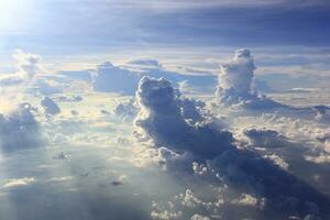 Soft focus of beautiful cloud and blue sky with sunset light from airplane window photo