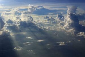 Soft focus of beautiful cloud and blue sky with sunset light from airplane window photo