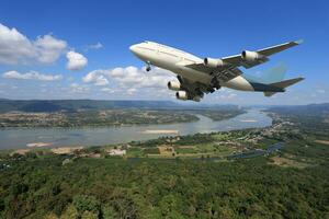 Airplane is flying above the clouds on beautiful sky background,Holidays and business concept photo