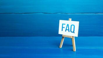 Easel with FAQ frequently asked questions. Available answers to overcome difficulties and misunderstandings. Guide, navigation. Tips, comments. Explanation in simple language. Instructions and rules photo
