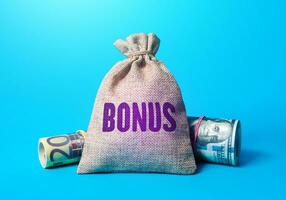 Money bag with word bonus. Rewarding employees with financial benefits. Receive rewards and preferences. Salary increase, promotions at work. Favorable purchase and special offers. photo