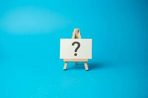 Question mark on the stand. Asking questions and seeking answers. Explore the unknown and seek information. Search for solutions. Critical thinking, evaluation, and analysis. photo