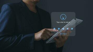 a businessman using application on tablet the virtual screen to give satisfaction in service.rating star very impressed.Customer service and Satisfaction concept. photo
