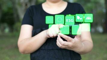 woman use smartphone at garden,and reduce global warming,climate change,ecology friendly investment,ESG environment social governance,Green Business Innovation and Sustainable Development concept photo