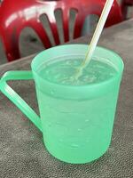 cool water in the plastic cup photo