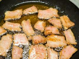 fried pork in pan, close up photo