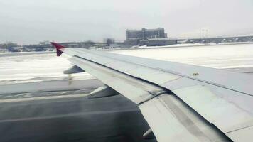 Wing of an airplane taking off in winter video