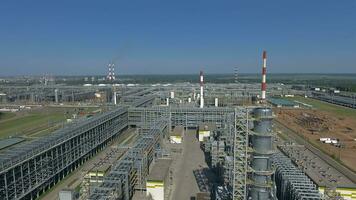 An aerial view of an oil refining complex against bright blue sky video