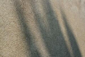 Cement and brick wall texture background, sun rays on the cement wall surface, smooth cement wall backdrop photo