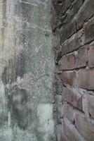 Weathered brick layer wall background, grungy brick texture surface, aged wall texture photo