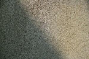 Sun shining on a cement wall background, grungy shiny wall surface, rusty cement wall backdrop photo