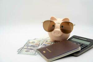 Travel planning and budget concept. Passport, Calculator, piggy bank and collecting money for vacation trip. Preparing for vacation. photo