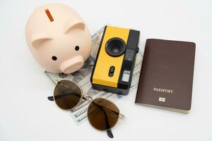Travel planning and budget concept. Film Camera, Passport, Calculator, piggy bank and collecting money for vacation trip. Preparing for vacation. photo