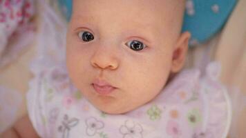 Cute three months baby girl with big blue eyes video