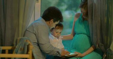 Familie, die den Abend mit Tablet-PC verbringt video