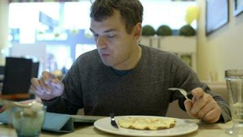 Man using pad and having dinner in cafe video