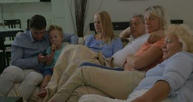 Family on the sofa watching TV together video