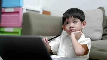 Asian boy studying online on laptop video