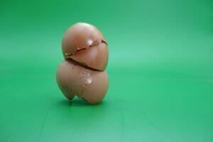 broken eggshell over green background. empty eggshells. photo