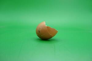 broken eggshell over green background. empty eggshells. photo