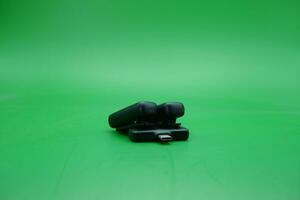 black wireless mic and receiver over green background. photo