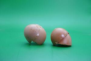 broken eggshell over green background. empty eggshells. photo