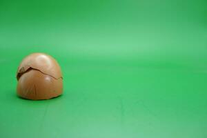 broken eggshell over green background. empty eggshells. photo