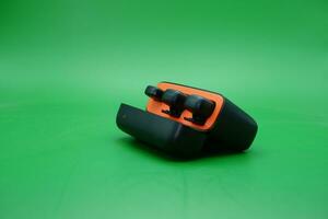 wireless mic with its charging case on a green background photo