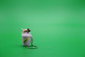 cute key chain isolated on green background. photo