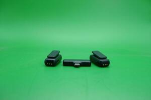 black wireless mic and receiver over green background. photo