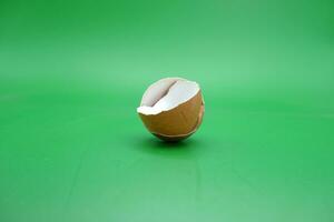 broken eggshell over green background. empty eggshells. photo