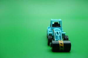 tandem roller toy in blue color isolated on green background. photo