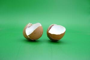 broken eggshell over green background. empty eggshells. photo