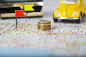 Wallet, coins, pass on a map. , Coins on a map. Mini car in the background. photo