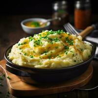 Creamy mashed potatoes with melted butter and chives photo
