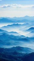 Hazy mountains seen through wispy clouds photo