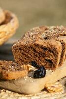 a loaf of bread with raisins and nuts on a cutting board photo