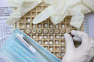 the word 'invisibility' is written on a board with a medical glove and a surgical photo