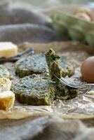 Baked omelette with spinach on a jammed baking paper photo