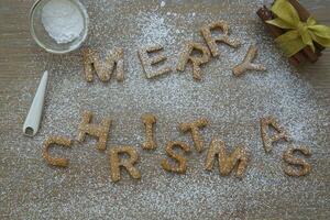 christmas letters and gingerbread on a wooden table photo