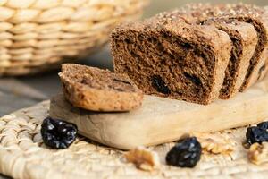 a loaf of bread with raisins and nuts on a cutting board photo