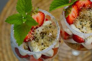 a dessert with strawberry in a glass photo